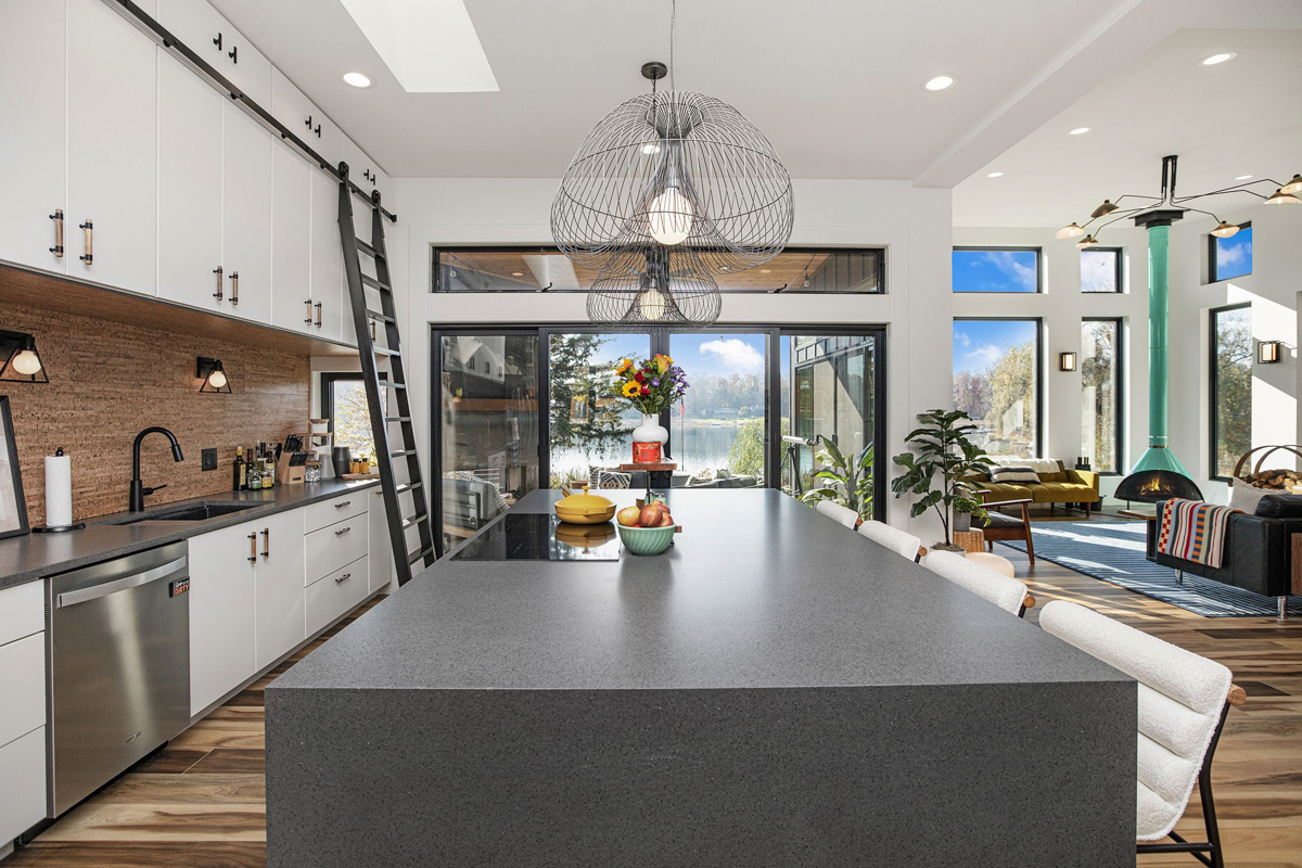 White and black slab door kitchen design with gray countertops and eclectic details