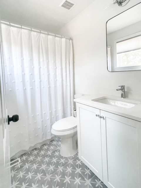 Single-sink white shaker bathroom vanity with white quartz countertops