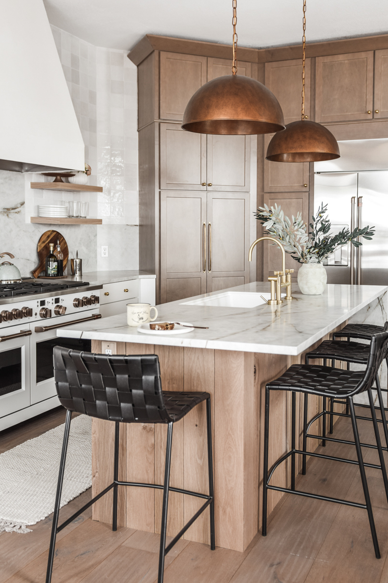 White shaker kitchen cabinets with a light wood shaker cabinet refrigerator surround and island