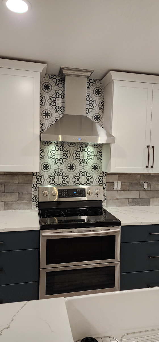 Farmhouse kitchen with white shaker wall cabinets and blue shaker base cabinets