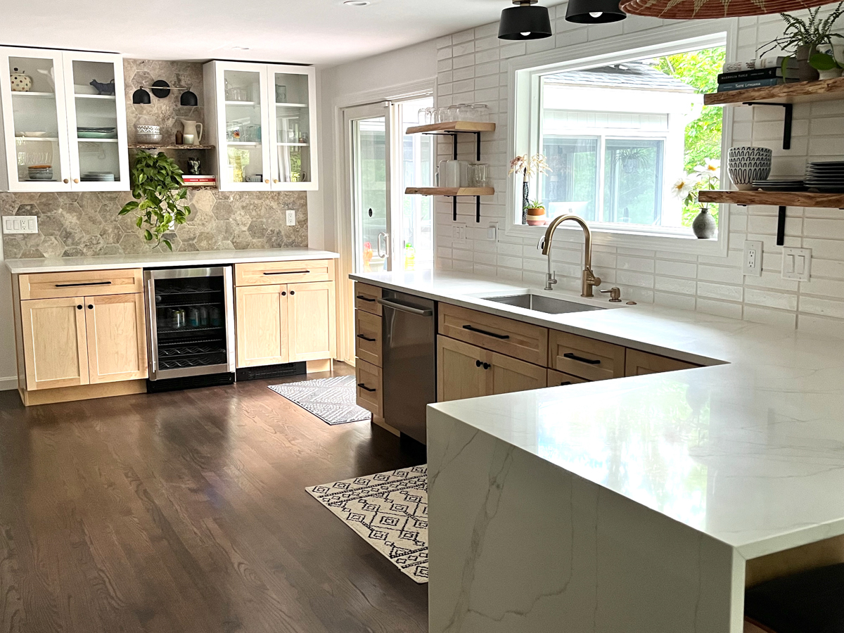 Natural wood shaker kitchen cabinet bases with white shaker wall cabinets with a mixture of stone and subway tile backsplash