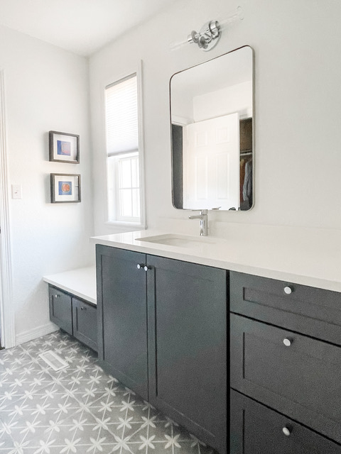 Dark gray shaker bathroom vanity cabinets with drawers and a white quartz countertop