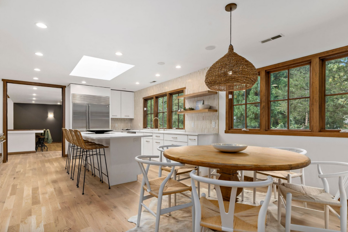 L-shaped white skinny shaker kitchen design with a kitchen island and white countertops