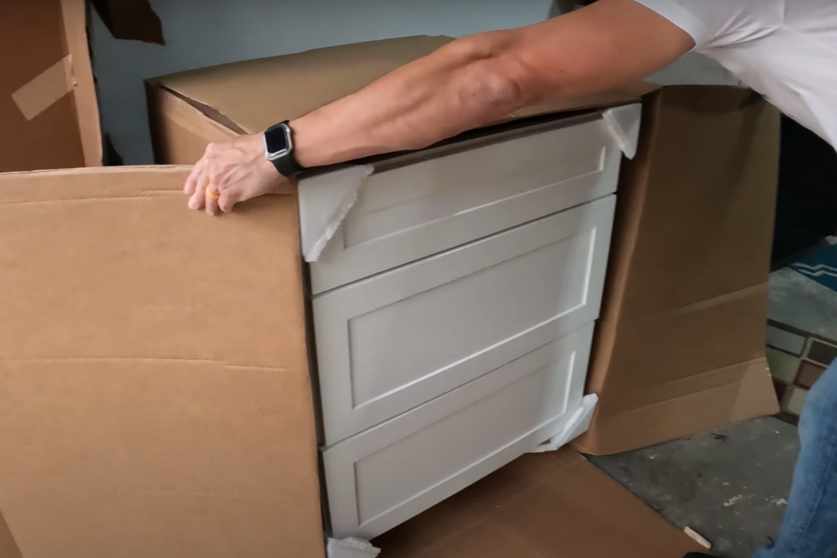 CliqStudios kitchen cabinet unboxing in a garage