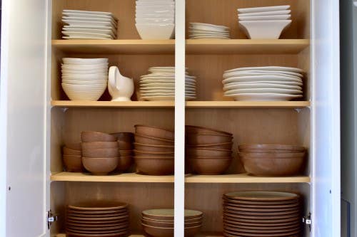 White kitchen shelving and storage with dishes inside