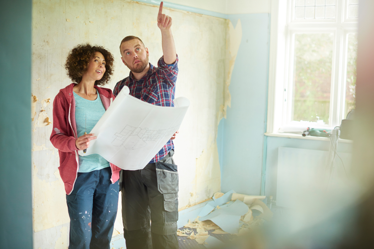 Contractor talking to client pointing out design details in her home