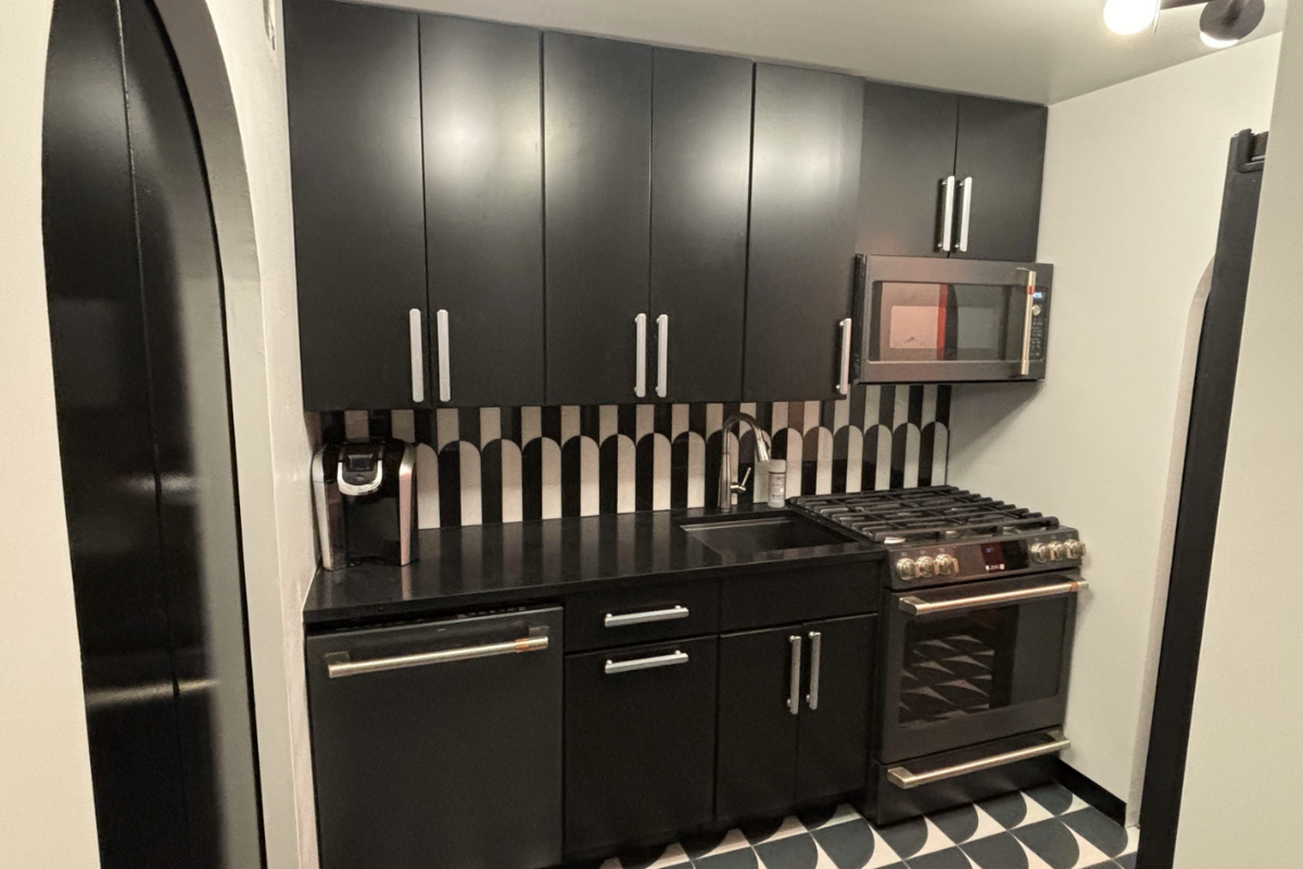 Small slab kitchen design with black cabinets and modern brushed nickel pulls