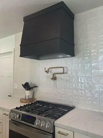 Black Colored Wood Range Hood installed in modern kitchen