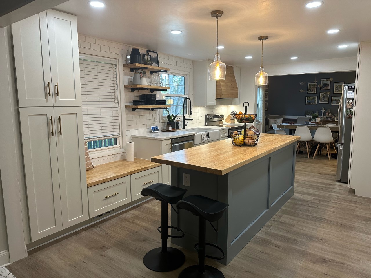 CliqStudios project: White shaker kitchen with pine wood hood and light gray island cabinets