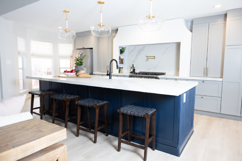 Elevated gray shaker kitchen design with large navy blue kitchen island and white quartz countertops