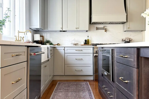 Transitional two-tone shaker kitchen design with beige cabinets and a dark brown stained island