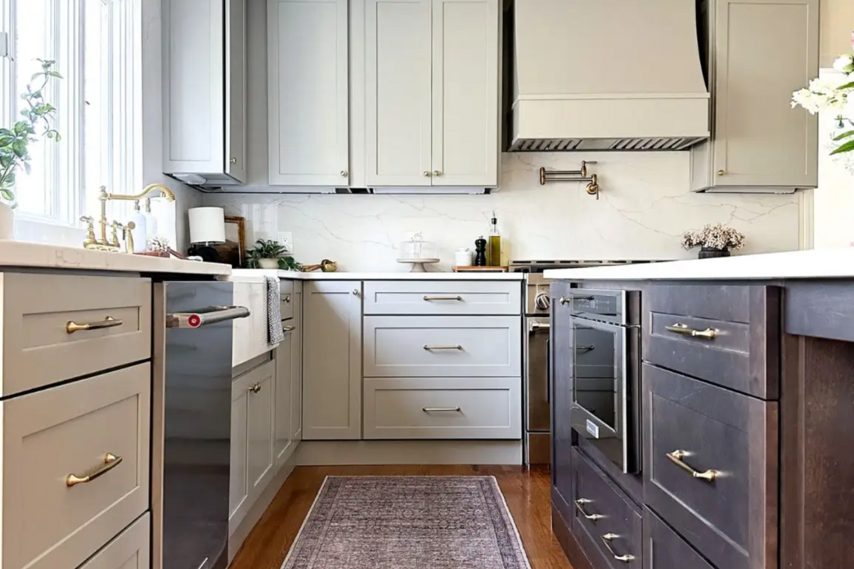 Light gray shaker kitchen design with dark wood island and farmhouse style flare