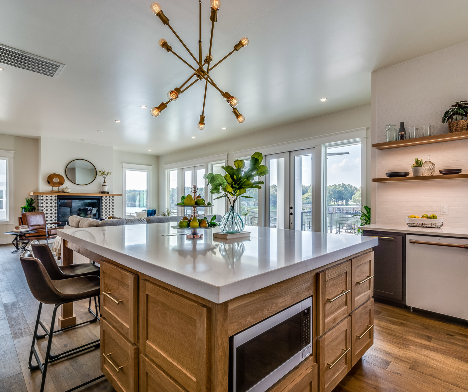 Oak and dark espresso colored shaker kitchen cabinets with large modern chandelier