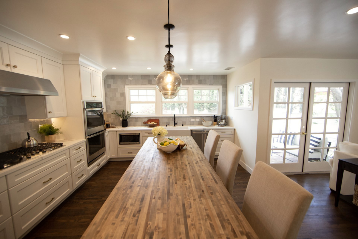 Decorative white shaker kitchen cabinets with white quartz countertops, gold hardware, and an indigo blue island with butcher block countertops Decorative white shaker kitchen cabinets with white quartz countertops, gold hardware, and an indigo blue island with butcher block countertops