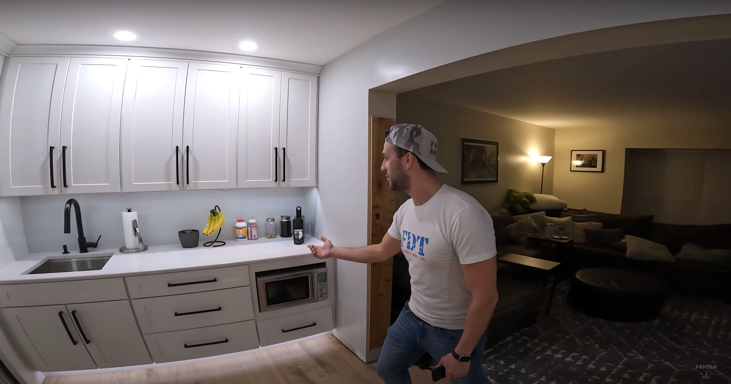 Refrigerator wall of white shaker kitchen cabinets with under cabinet lighting and toe kick lighting