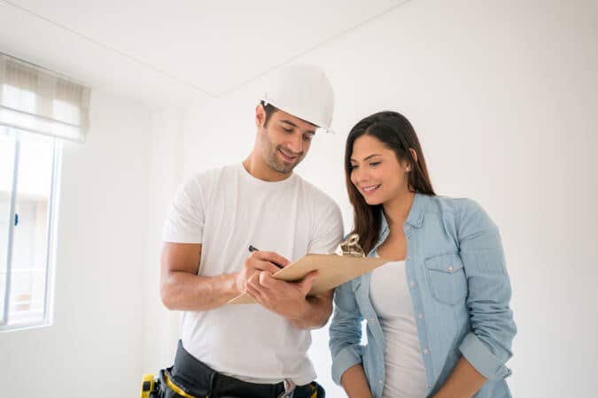 Homeowner meeting with her contractor in a hard hat