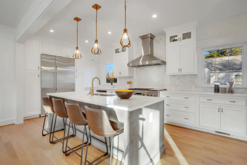 White inset shaker cabinet kitchen design with stacked glass cabinets and a gray wood stained island