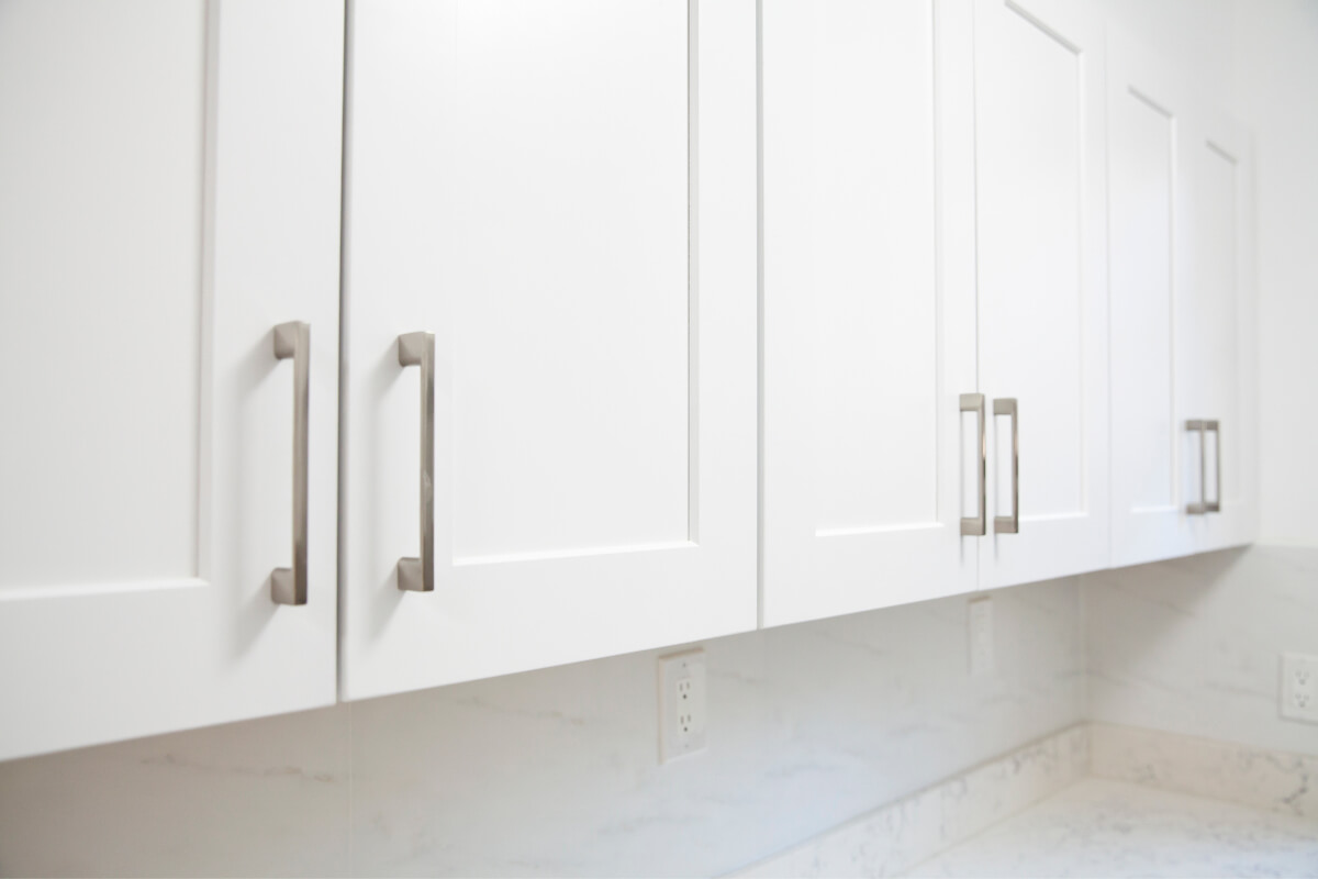 Full overlay white shaker wall cabinets with brushed nickel cabinet handles 