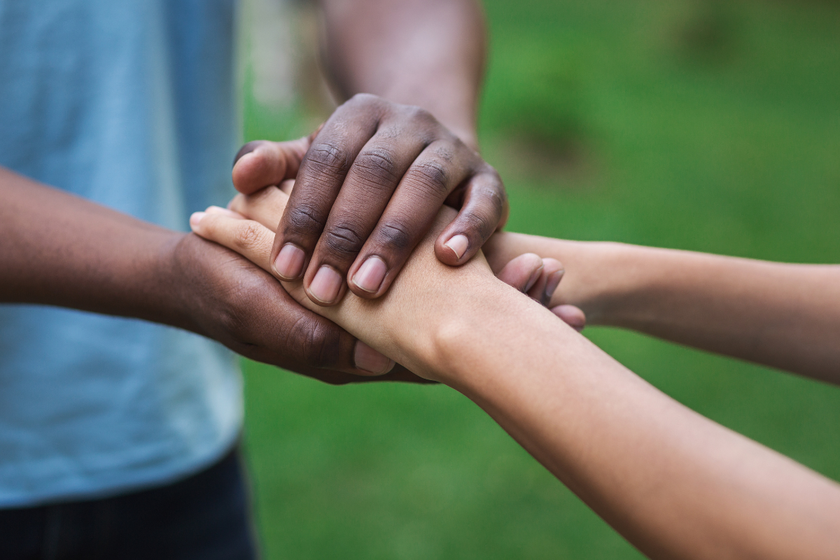 Two people graciously shaking hands in partnership