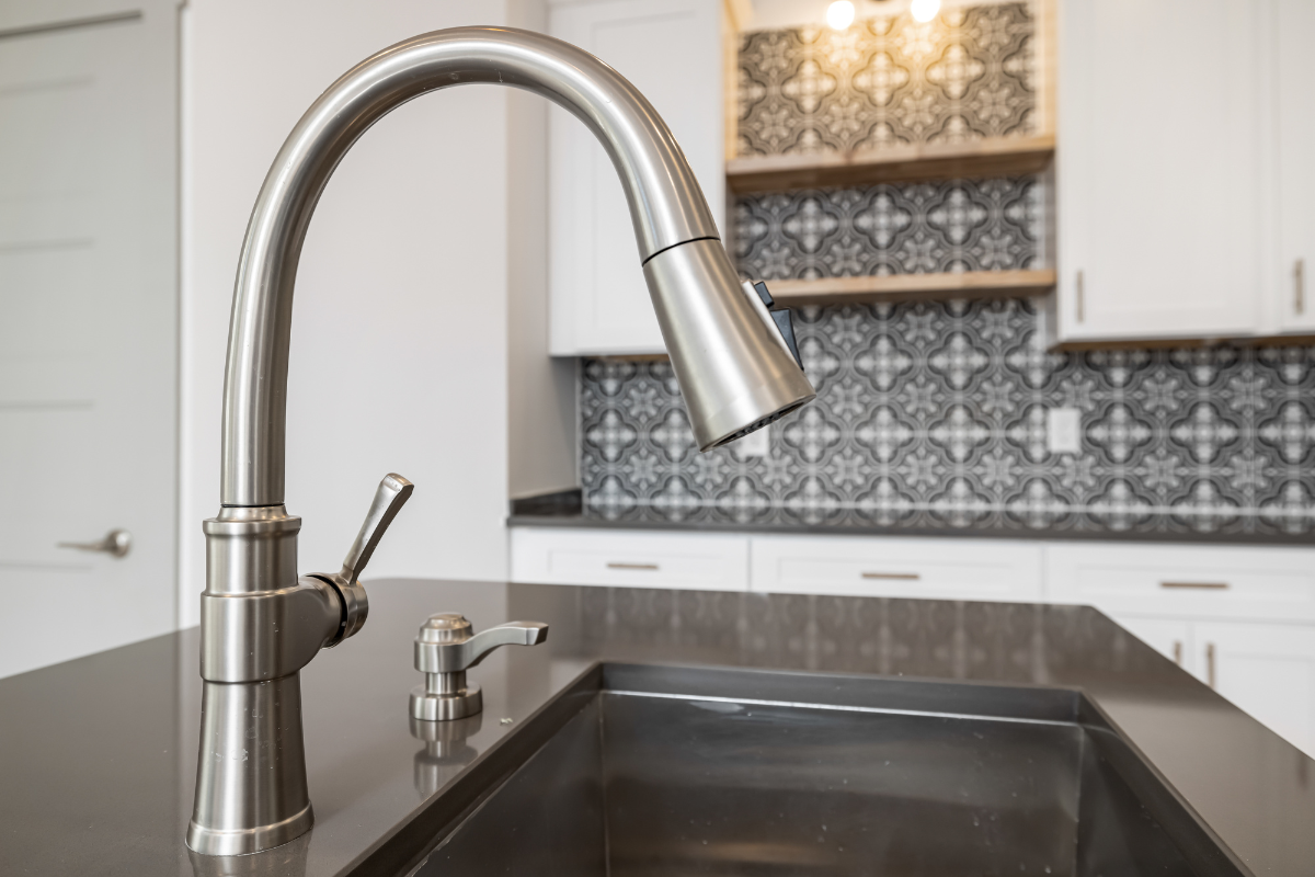 Brushed nickel goose-neck faucet with pull-down sprayer