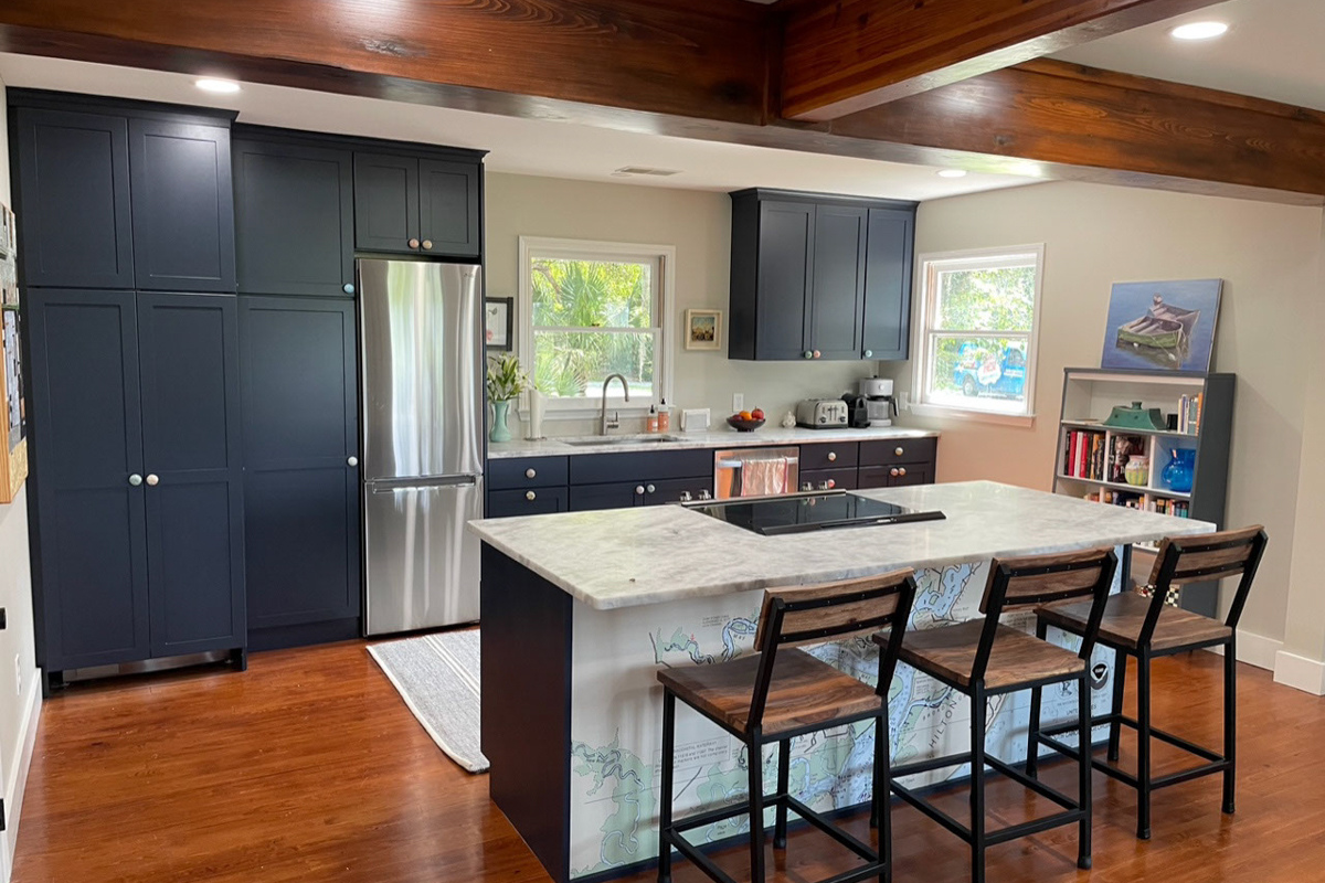 Dark navy blue shaker kitchen design with nautical theme and light quartz countertops
