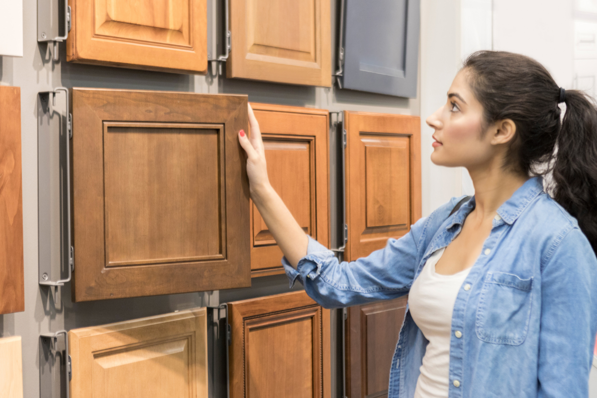 Homeowner looking at kitchen cabinet door styles