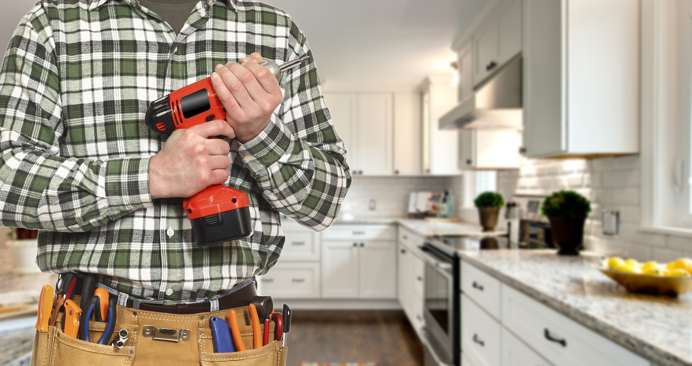 Contractor with power drill ready to install white shaker kitchen cabinets