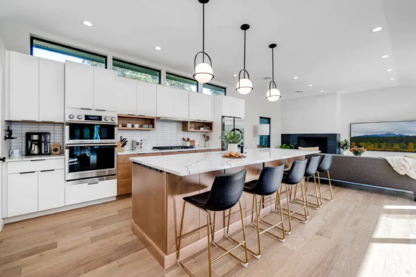 Mid-Century Modern kitchen design with slab door cabinets in white and a warm wood-toned island