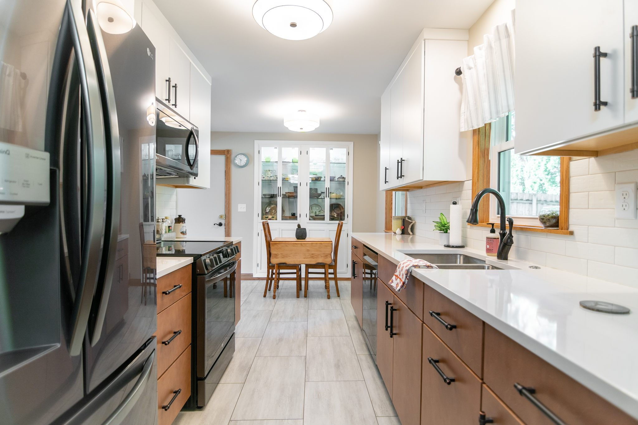 CliqStudios project: White and natural wood slab kitchen cabinets with white subway tile backsplash