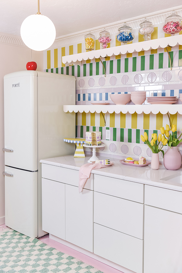 CliqStudios project: Light cream slab kitchen cabinets with a retro flare and pops of colorful decor