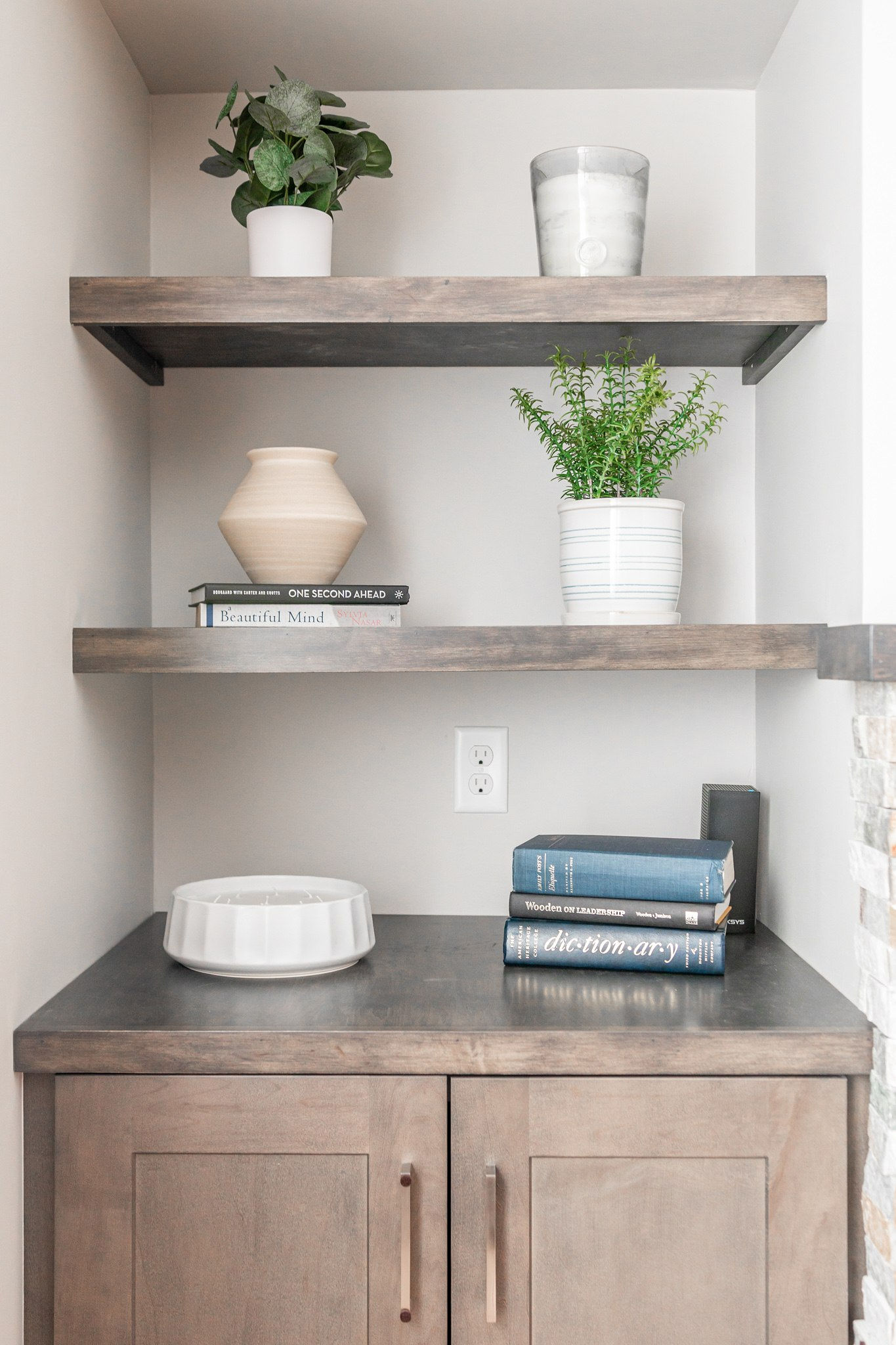 CliqStudios project: Warm wood shaker cabinets in small entertainment center with floating shelves