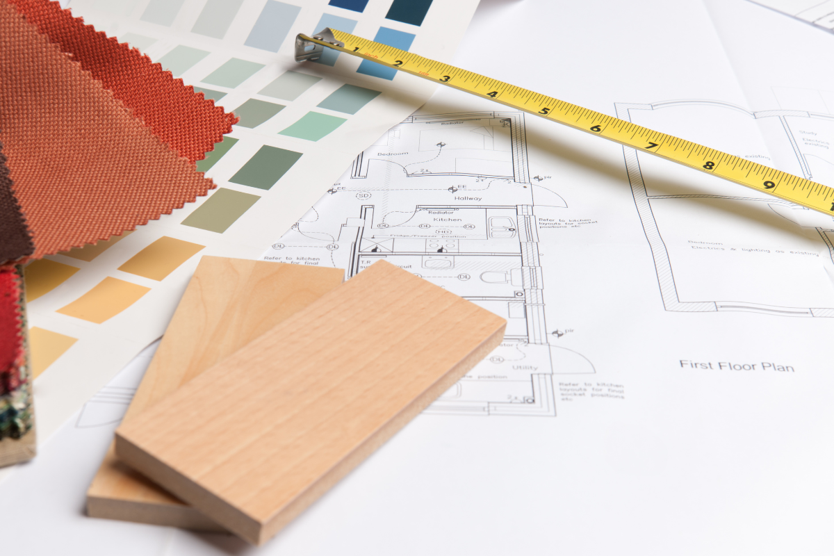 Wood and paint samples laid out on a table with a tape measure