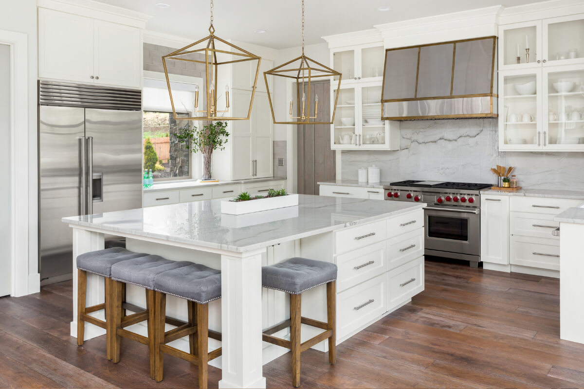 Large white shaker kitchen with decorative island and white stone countertops