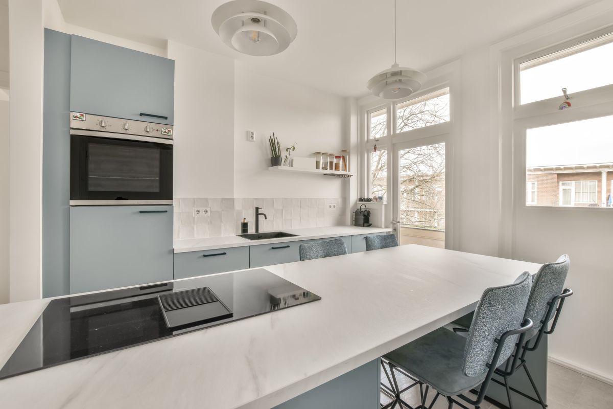Light blue slab kitchen cabinet design with white countertops and downdraft range hood (1200 × 800 px).png Light blue slab kitchen cabinet design with white countertops and downdraft range hood (1200 × 800 px).png