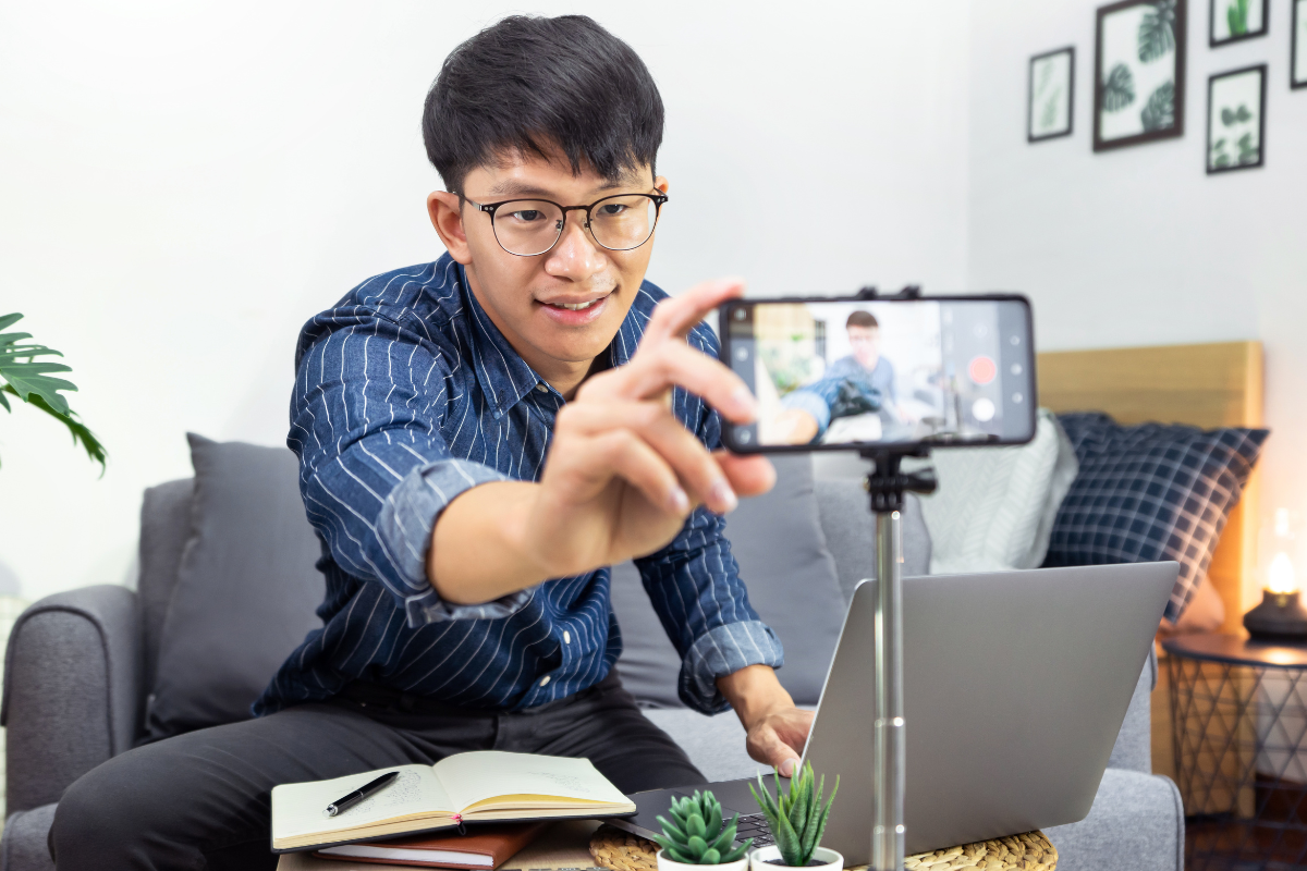 Young man recording a video of himself on his phone