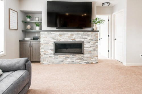 Medium tone wood kitchen cabinets with floating shelves above