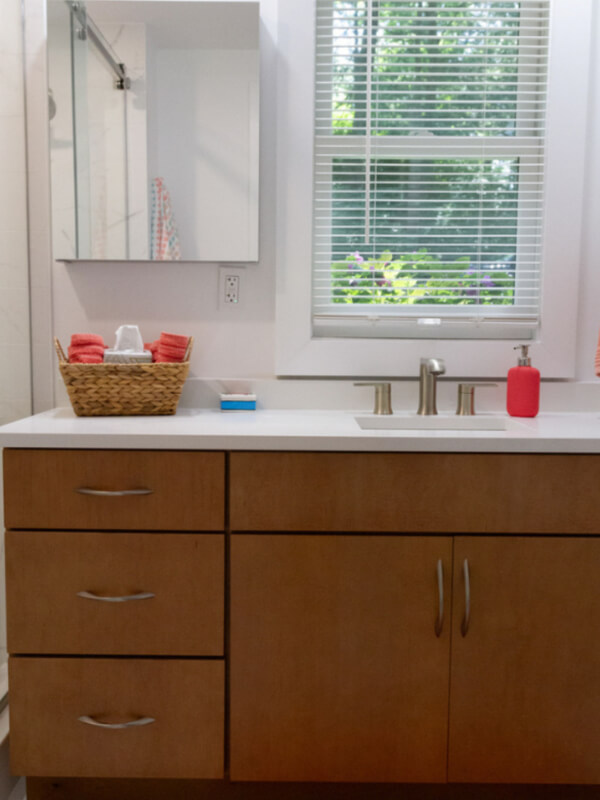 Medium wood tone vanity cabinet in slab door style