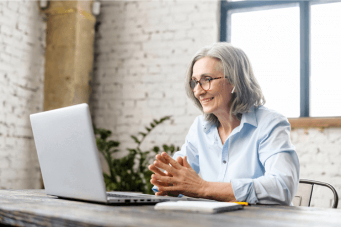 Older woman on a virtual conference with ear buds