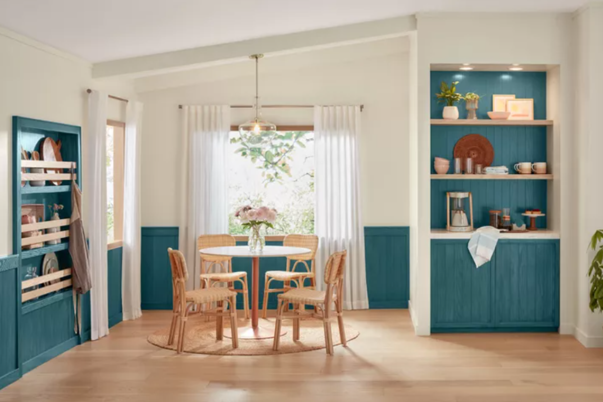 Dark teal built-in bookcase cabinets in a light dining room