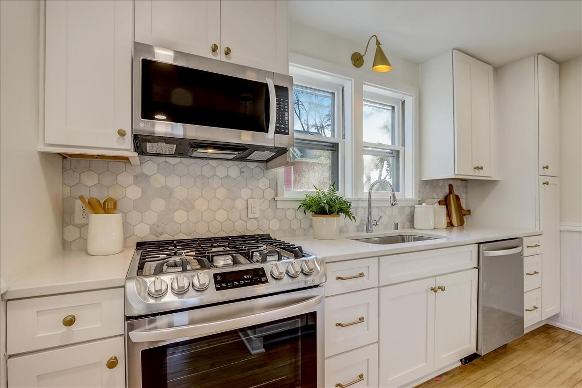 CliqStudios project: One wall shaker white kitchen cabinets in Victorian home with gold accents and marble backsplash