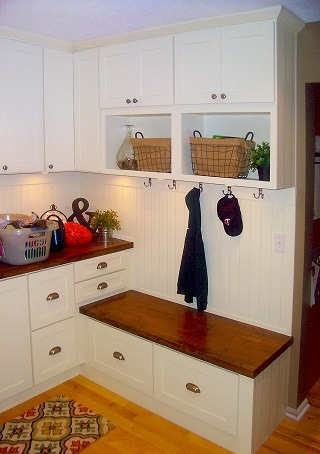 Laundry room cabinets with shoe bench, open cubbies and countertop in white shaker style