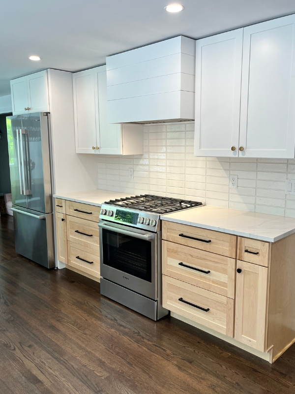 Range wall design with white shaker wall cabinets and a shiplap box wood kitchen hood with natural wood shaker base cabinets Range wall design with white shaker wall cabinets and a shiplap box wood kitchen hood with natural wood shaker base cabinets