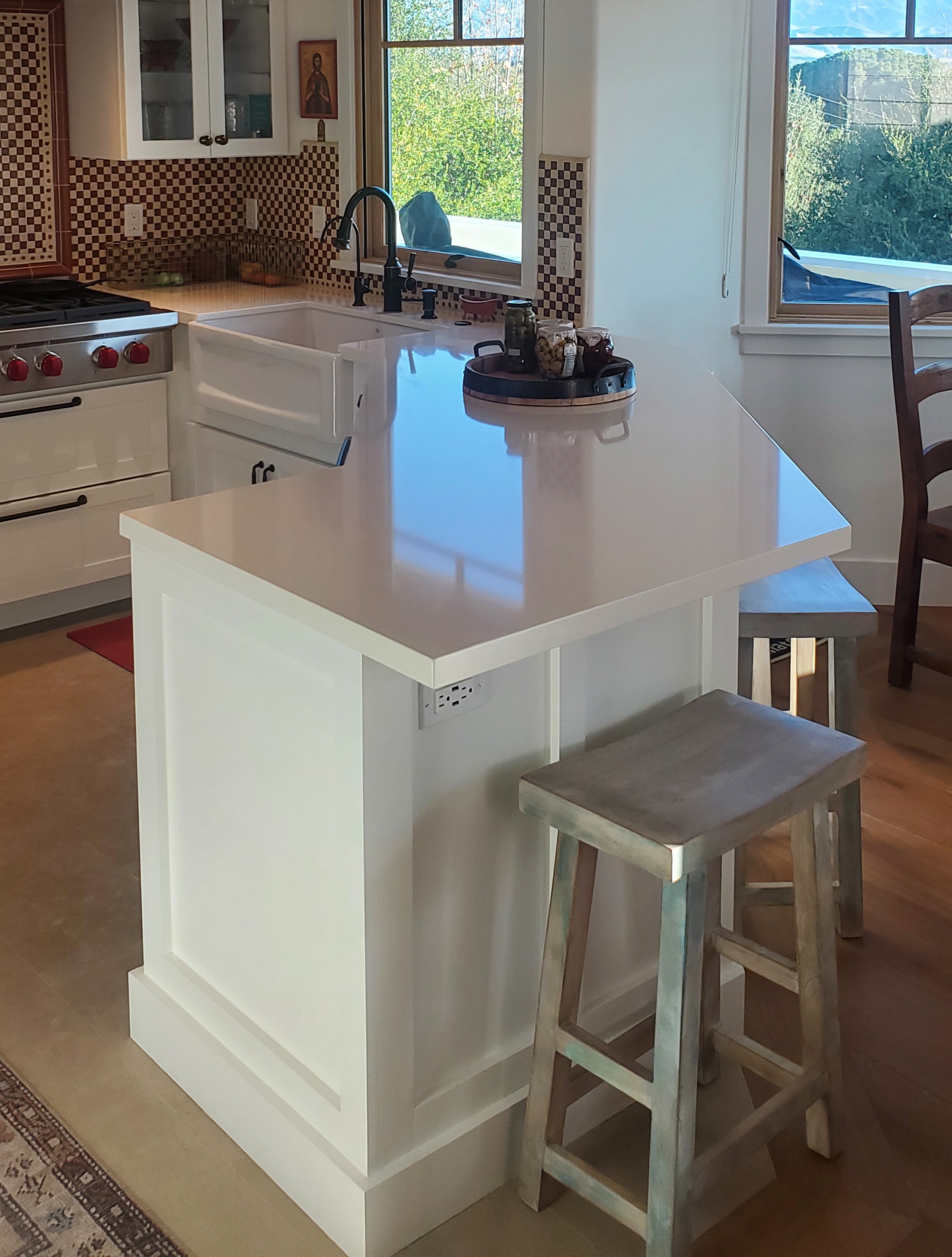 CliqStudios project: White shaker kitchen cabinets with a large white farm sink and Italian-style tile backsplash