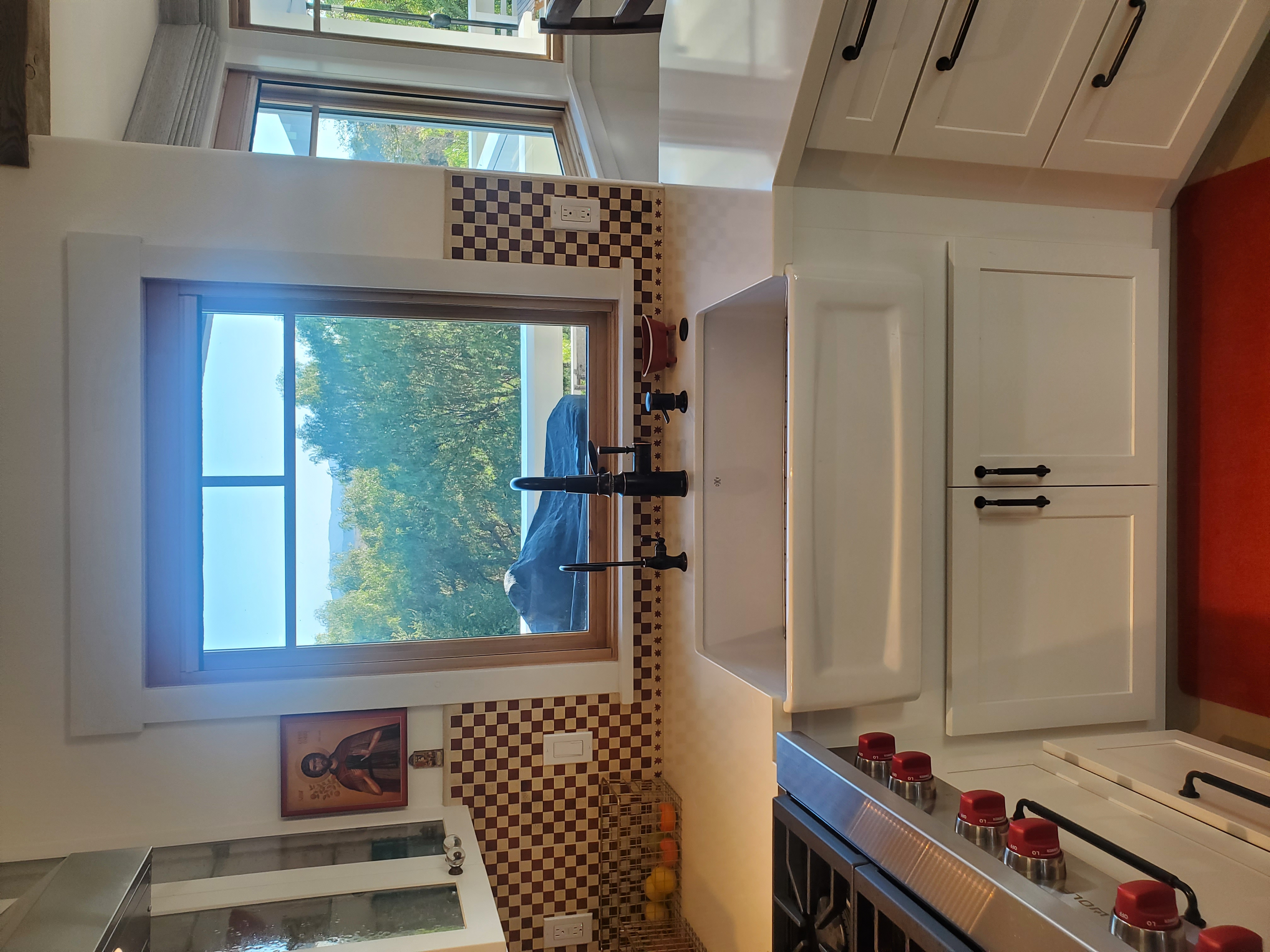 CliqStudios project: White shaker kitchen cabinets with a large white farm sink and Italian-style tile backsplash