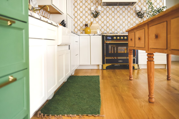 CliqStudios project: Light cream shaker kitchen cabinets with green and floral Scandinavian accents