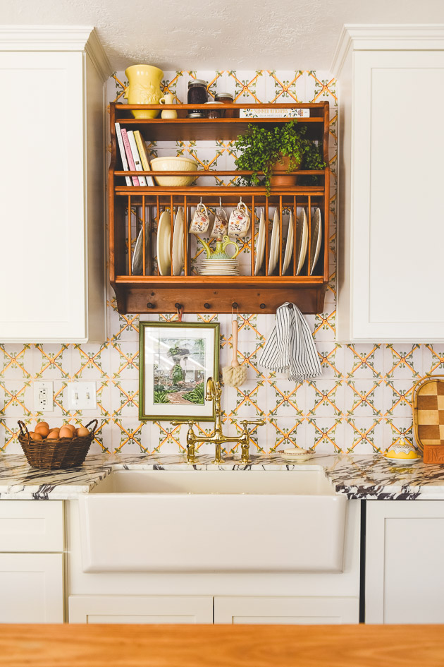 CliqStudios project: Light cream shaker kitchen cabinets with green and floral Scandinavian accents