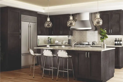 L-shaped dark brown shaker cabinet kitchen with eat-in island seating and brushed nickel cabinet pulls