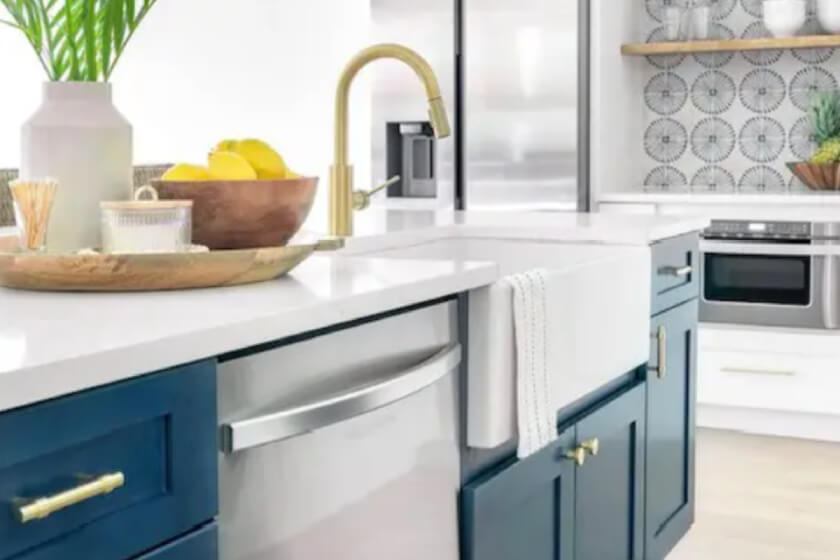 White beachy shaker kitchen design with wood floating shelves and navy blue island cabinets