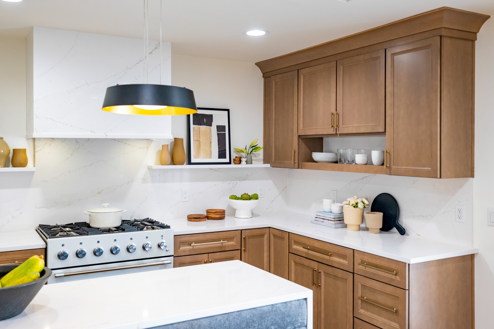 CliqStudios project: Detailed wood shaker door kitchen cabinets with indigo colored island cabinets and white quartz waterfall countertops