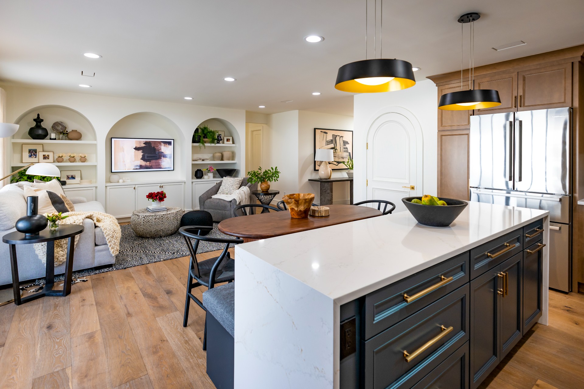 CliqStudios project: Detailed wood shaker door kitchen cabinets with indigo colored island cabinets and white quartz waterfall countertops